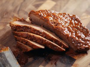 Closed up of sliced brisket on wooden cutting board