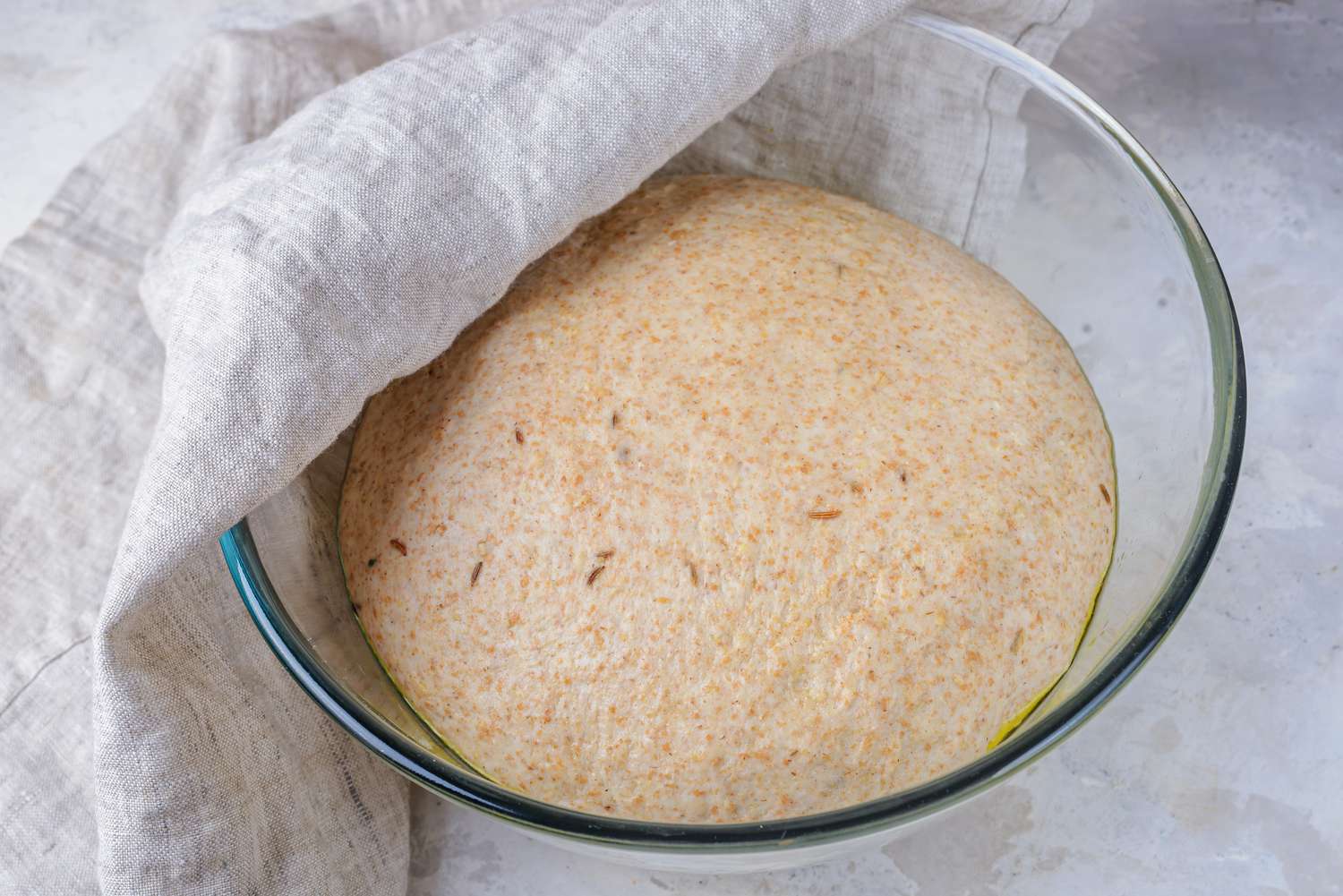 Covering dough with a dish towel