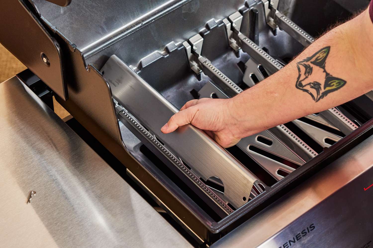 Person adjusting a component of Weber Genesis EX-325S Propane Gas Smart Grill