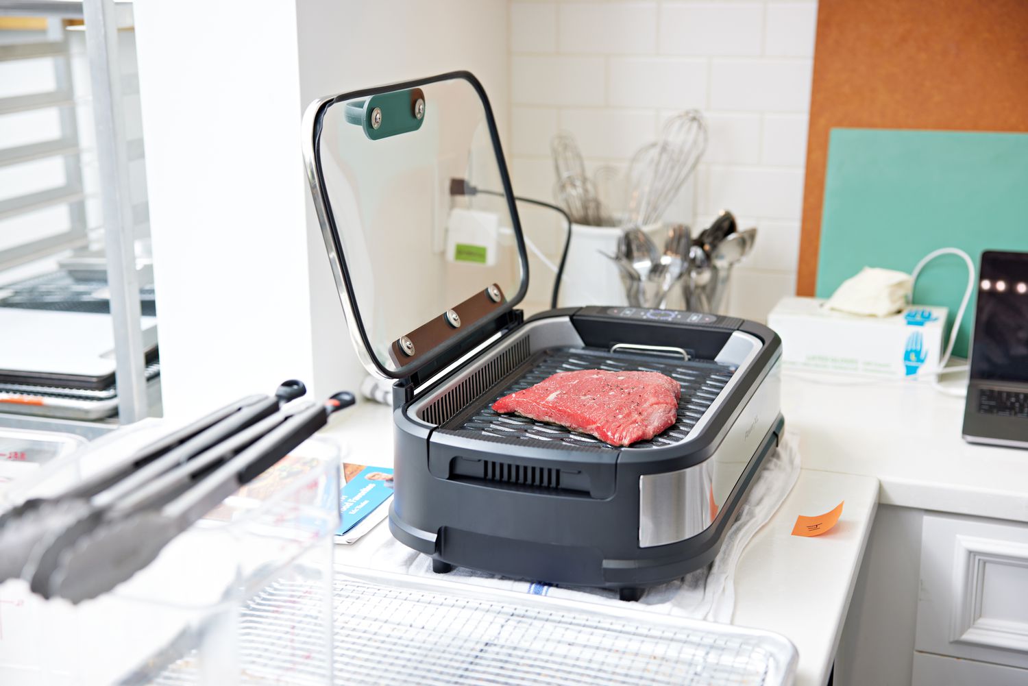 Steak cooking on the Power XL Smokeless Grill in a kitchen 