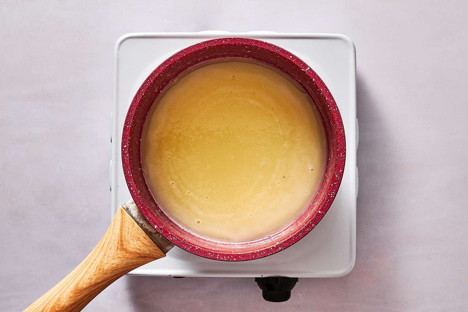 condensed milk, sugar, and water in saucepan