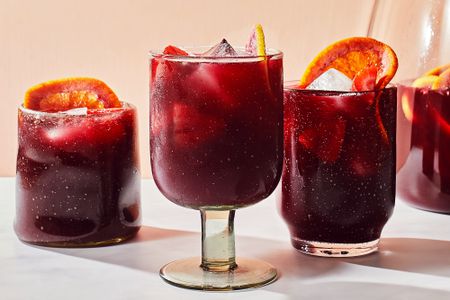 Three glasses of hard seltzer sangria garnished with orange slices