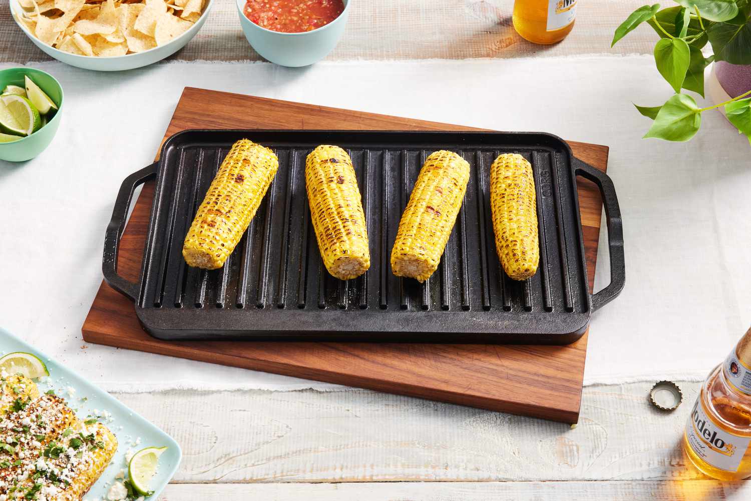 Grilled corn on the Lodge Cast Iron Reversible Grill/Griddle that is sitting on a table. 