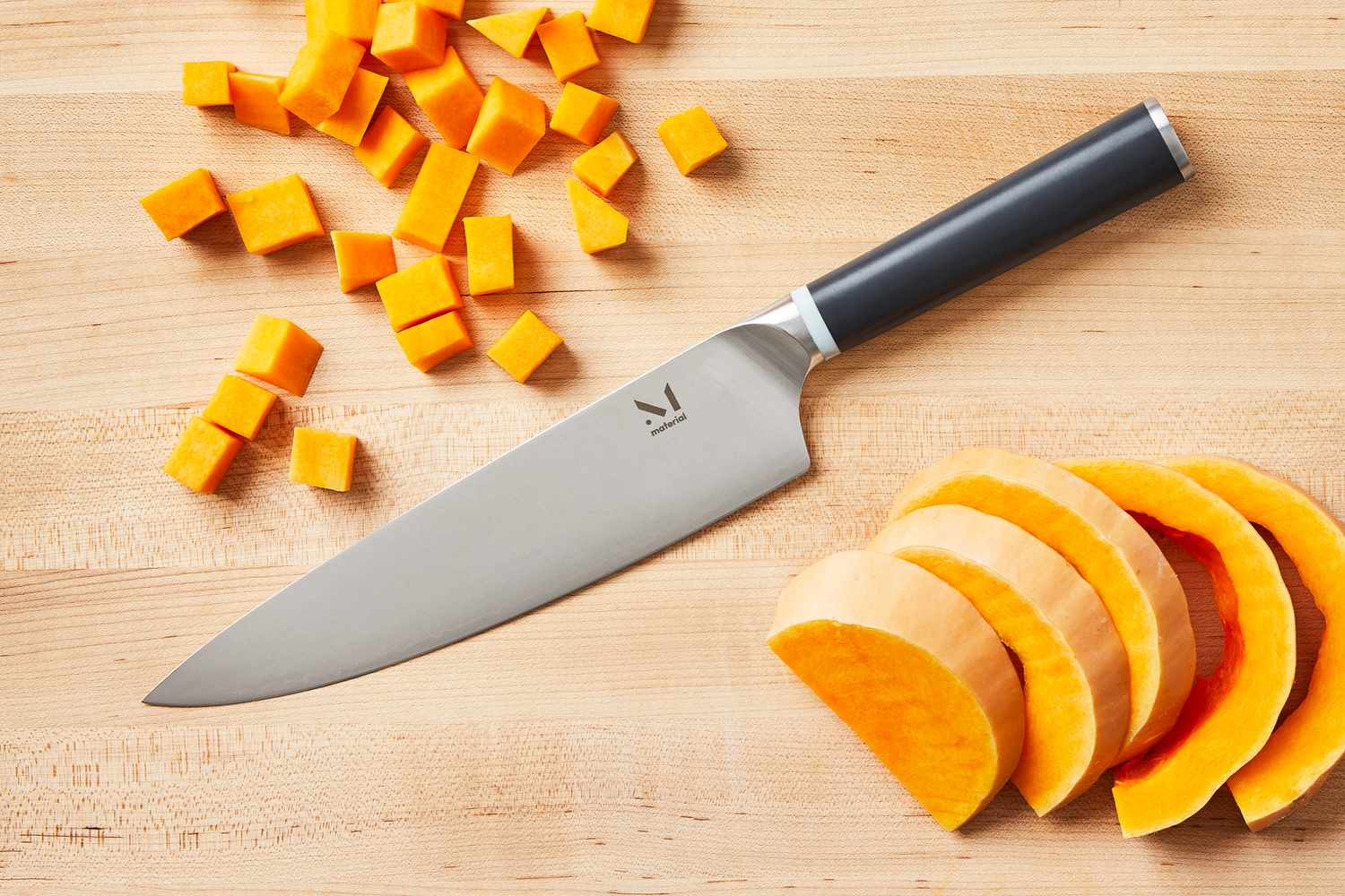 Material The 8-Inch Knife on a wooden cutting board with sliced and diced butternut squash