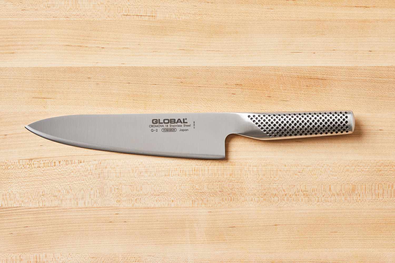 Global 8-Inch Chef's Knife displayed on a wooden cutting board