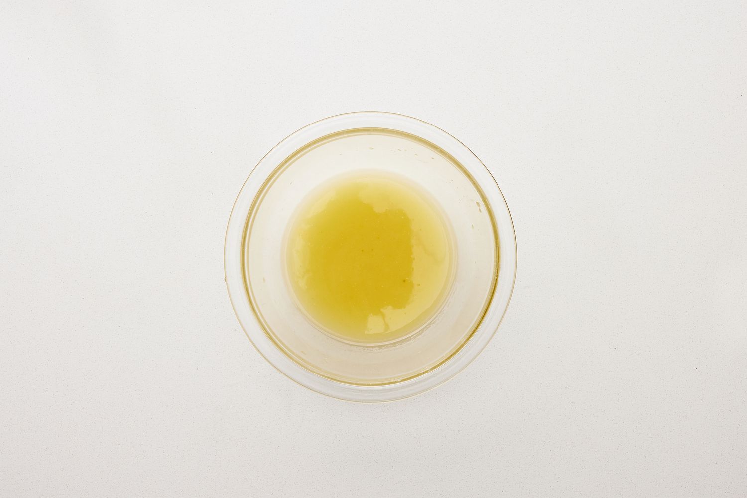 A small bowl of charred lemon juice-olive oil dressing