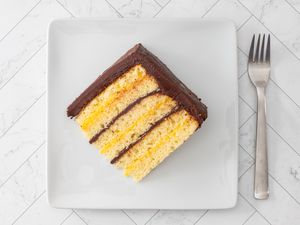 slice of doberge cake with lemon and chocolate filling