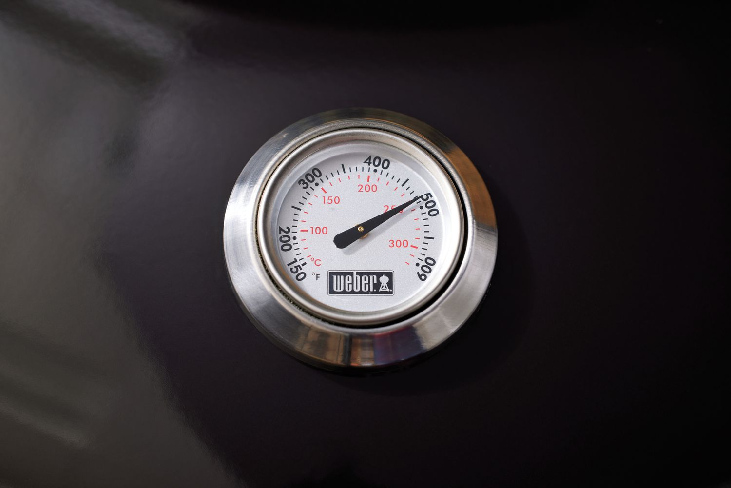 Closeup of the temperature gauge on a Weber Original Kettle Premium 22-Inch Charcoal Grill