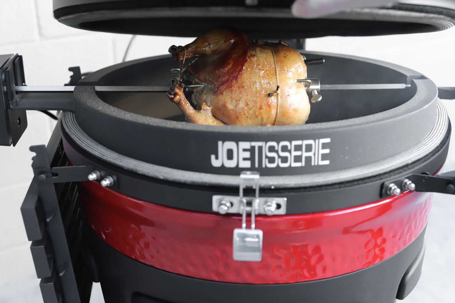 A rotisserie chicken being cooking n the Kamado Joe Konnected Joe