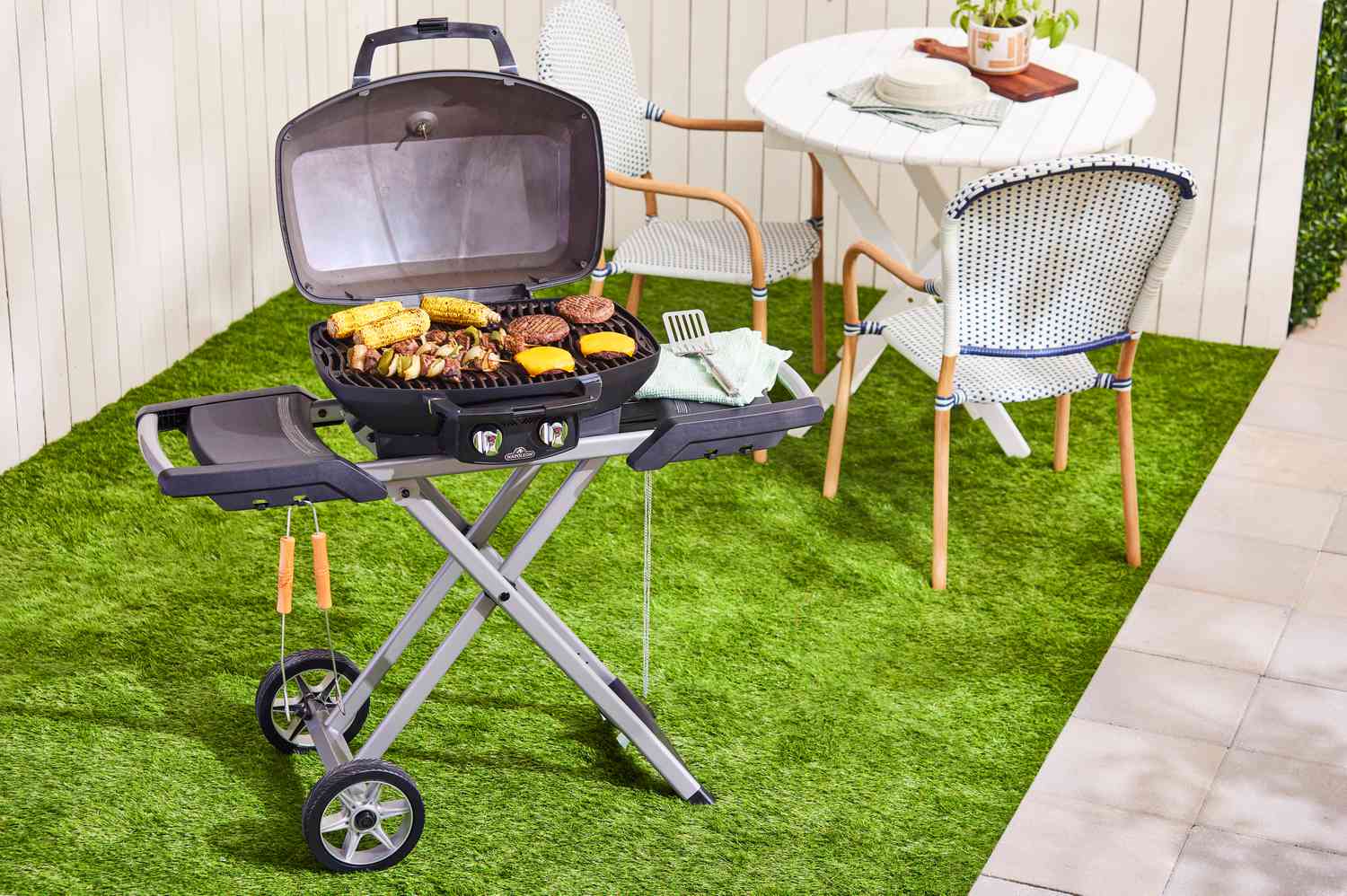 Napoleon TravelQ PRO285X grilling burgers, kebabs, and corn
