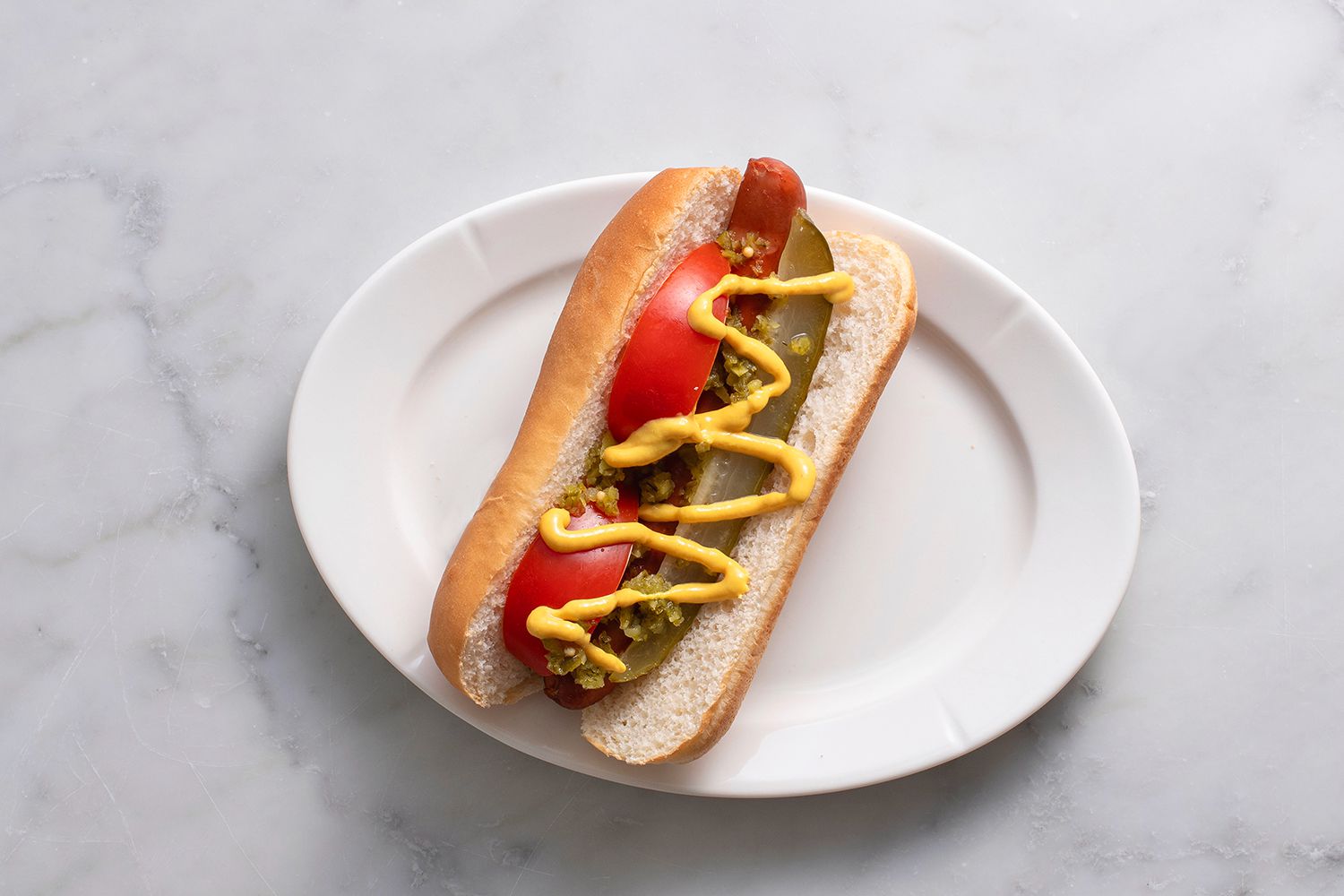 Hot dog topped with relish and mustard