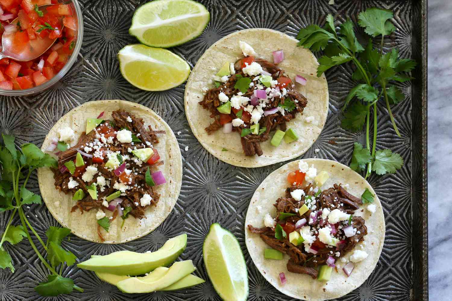 Barbacoa tacos with fixings.