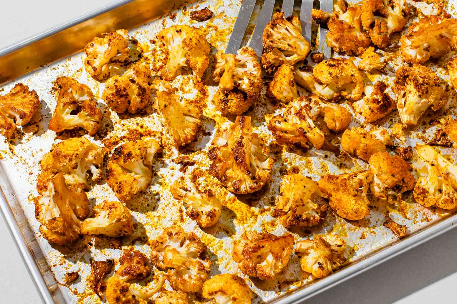 Spicy roasted cauliflower on a baking sheet