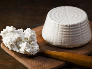 Ricotta Cheese on wooden board and spoon