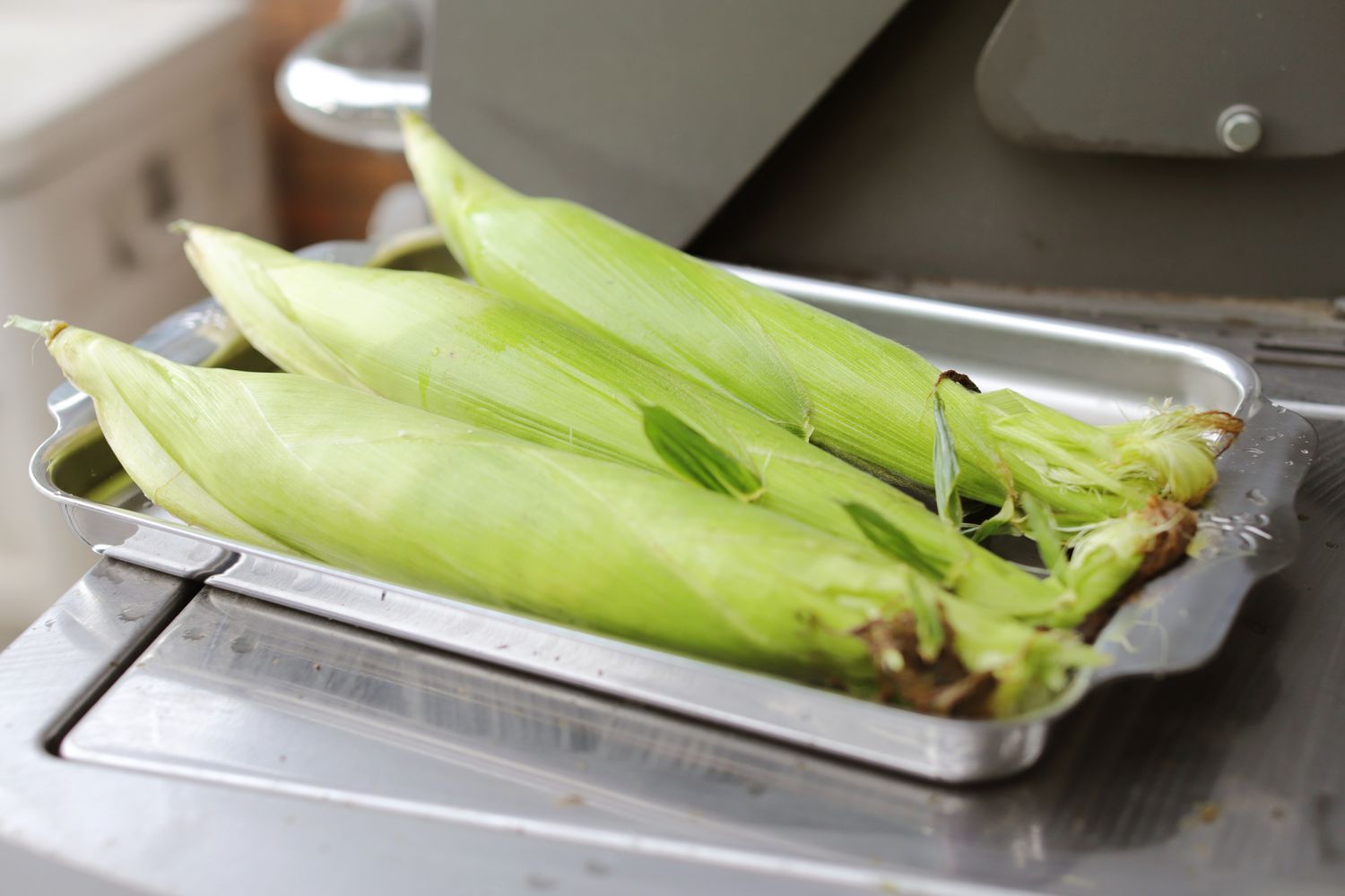 Fresh corn on a Hestan Provisions OvenBond Tri-ply 3-Piece Set sheet pan