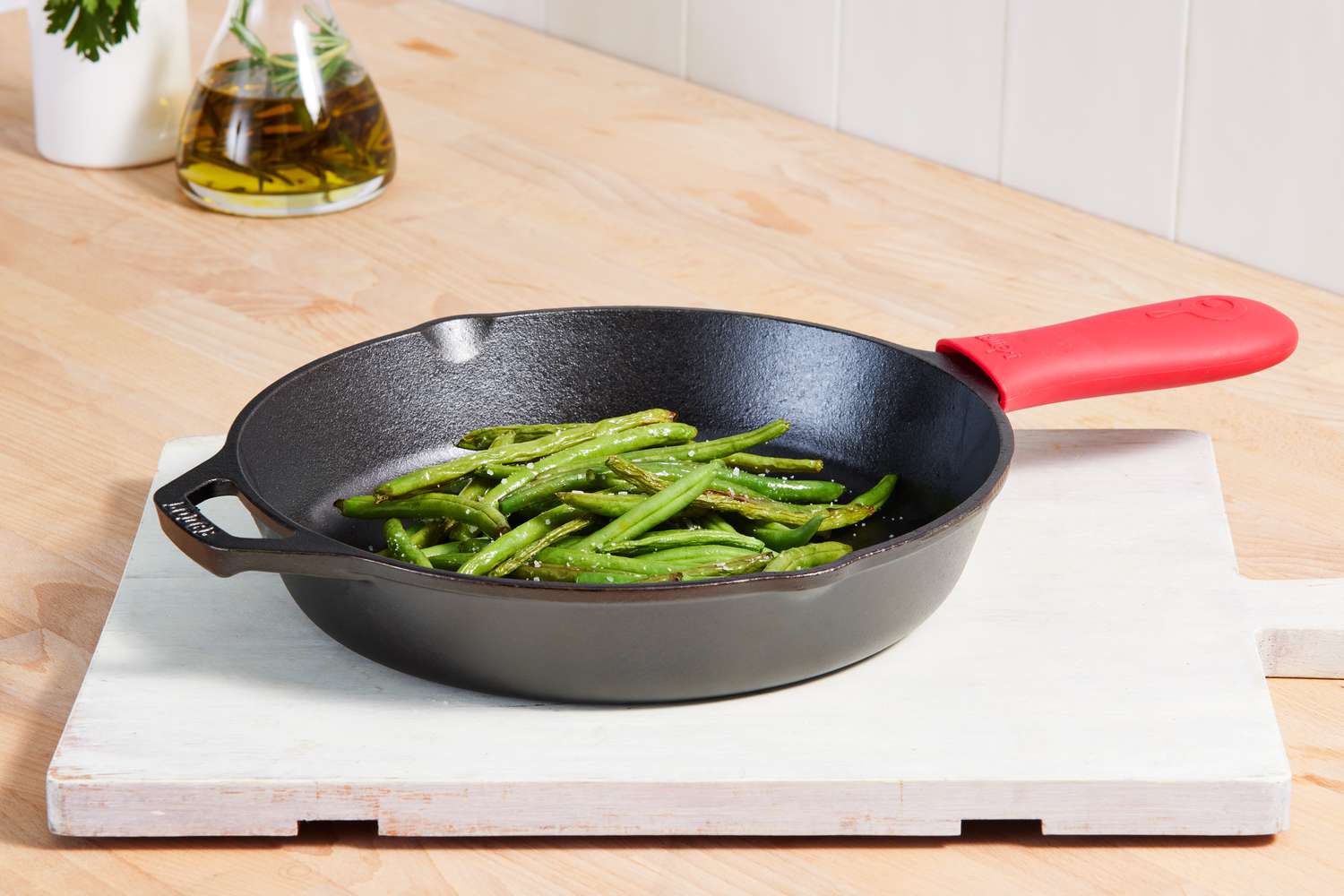 Green beans in the Lodge Pre-Seasoned Cast Iron displayed on a wooden cutting board