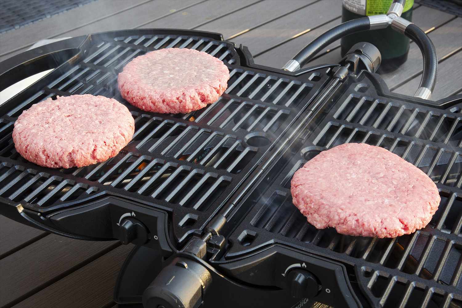 nomadiq-portable-propane-gas-grill with burgers grilling on top