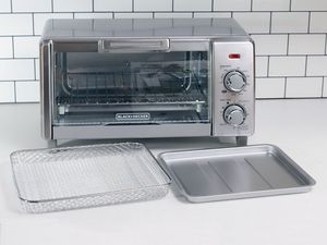 Black+Decker Crisp N' Bake Air Fry 4-Slice Toaster displayed on a white kitchen counter with tiles in the background 
