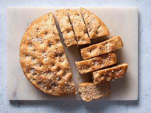 Black Pepper Focaccia sliced on a cutting board 