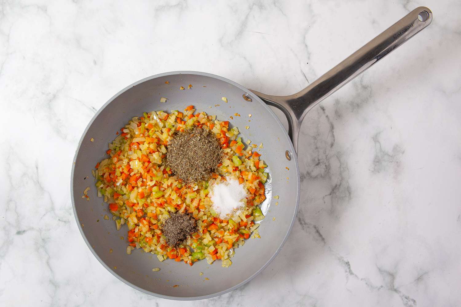 Seasonings added to vegetable mixture in the frying pan