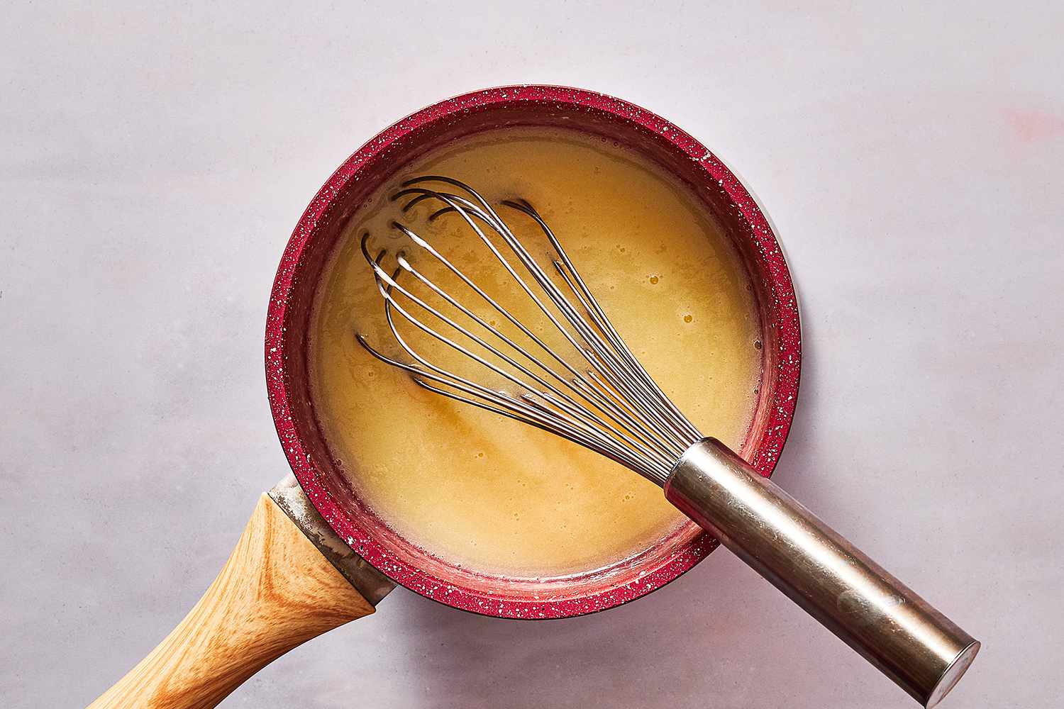 mirror glaze mixture in pan with whisk