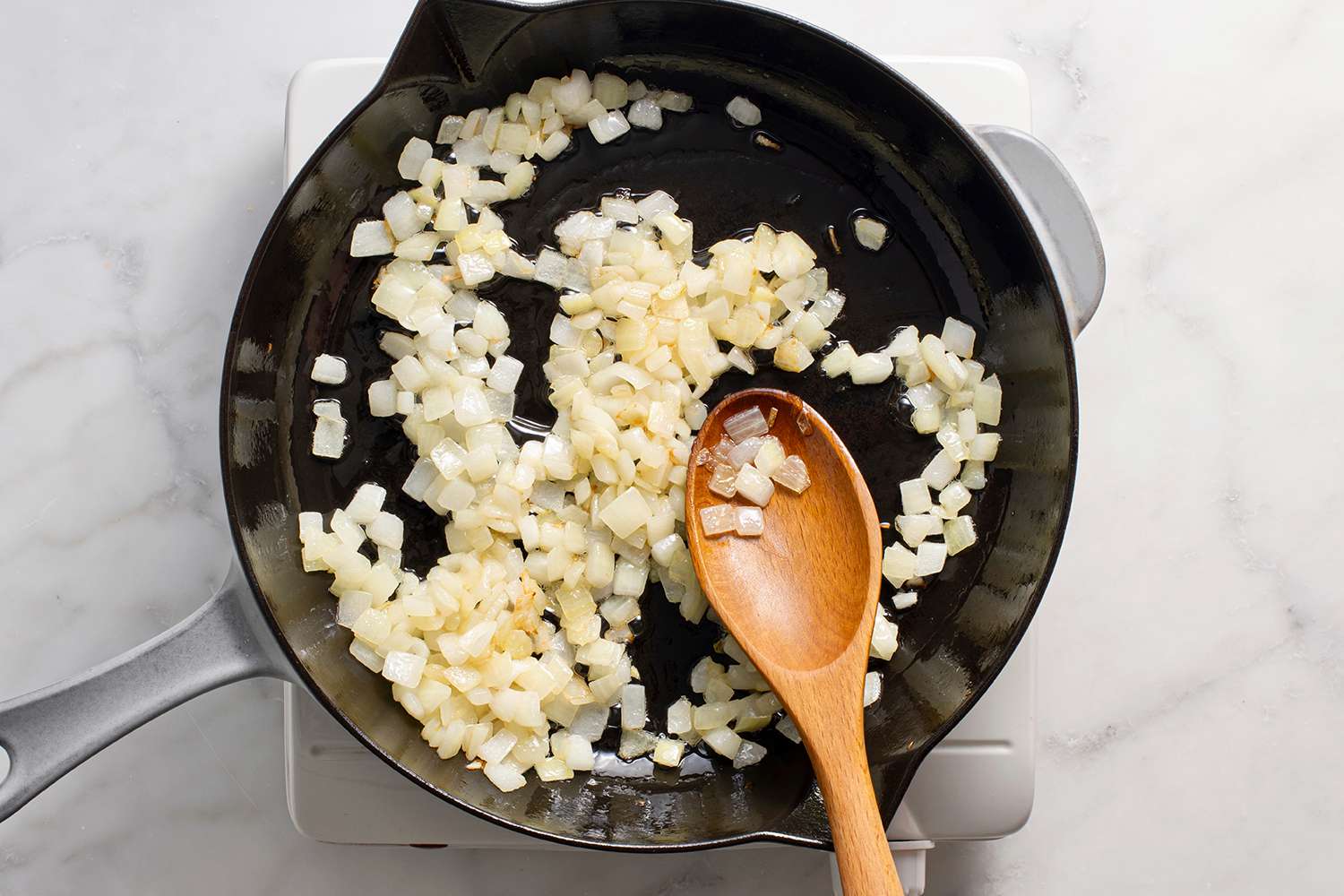 Diced onions cooking in a pan