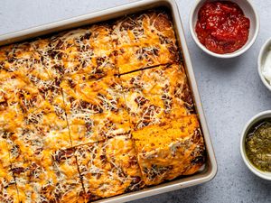 tomato soup snacking cake in pan with toppings in bowls