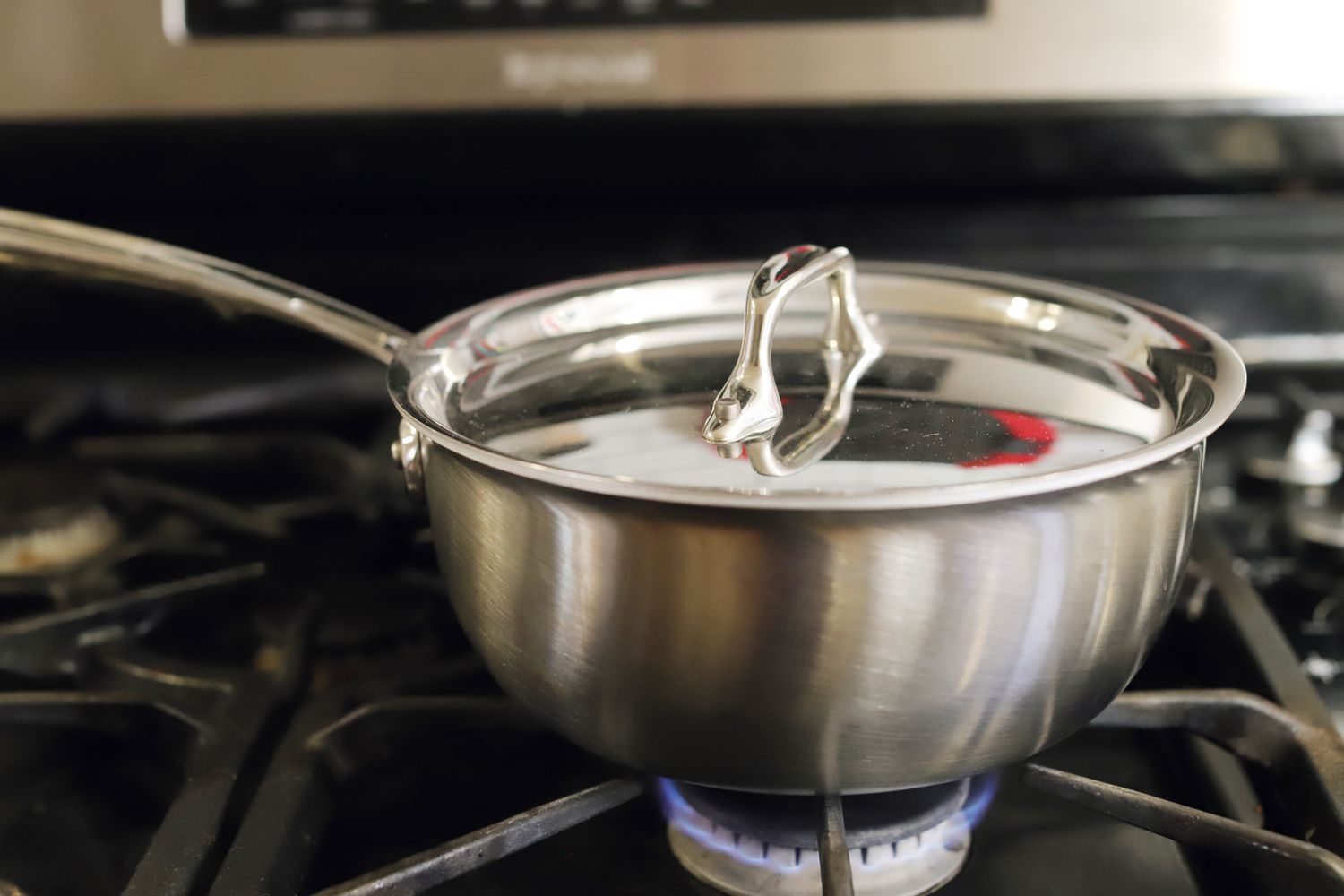 The All-Clad G5, with lid on, atop a gas stove