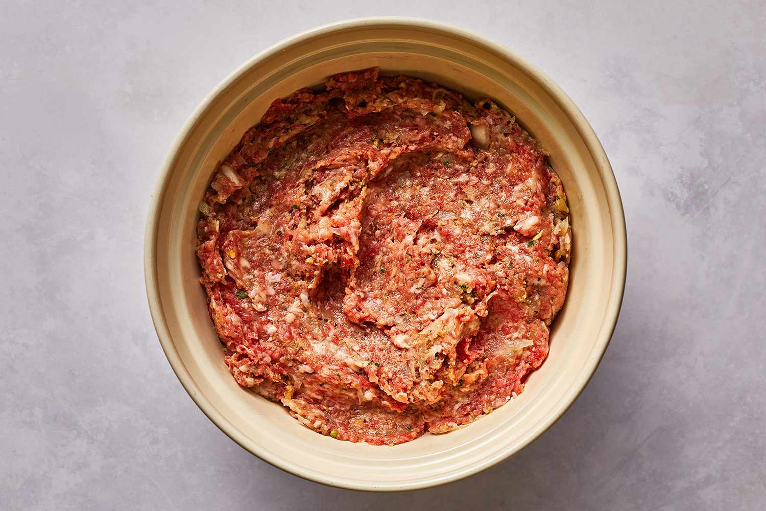 Beef, sausage, onion, garlic, breadcrumbs, Italian seasoning, and black pepper in a bowl