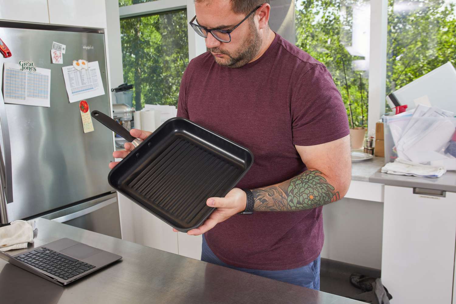 A person holding the OXO Good Grips 11” Square Grill Pan.
