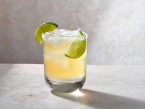 A beer margarita served with lime wedges