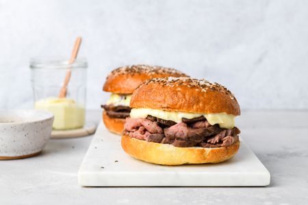 Two Beef on Wecks resting on a marble platter