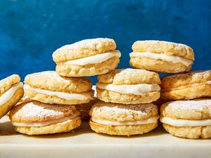 Stacks of Polish lemon sandwich tea cookies on a marble serving board