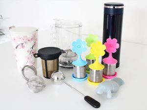 Assortment of tea infusers displayed on a white countertop 