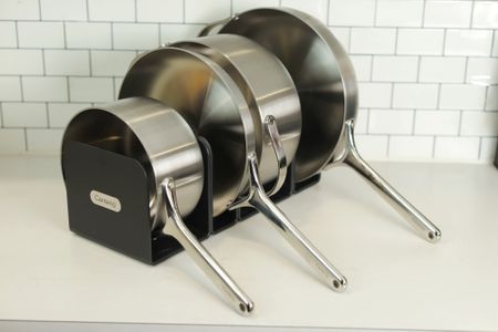 Caraway Stainless Steel Cookware set displayed in kitchen on rack