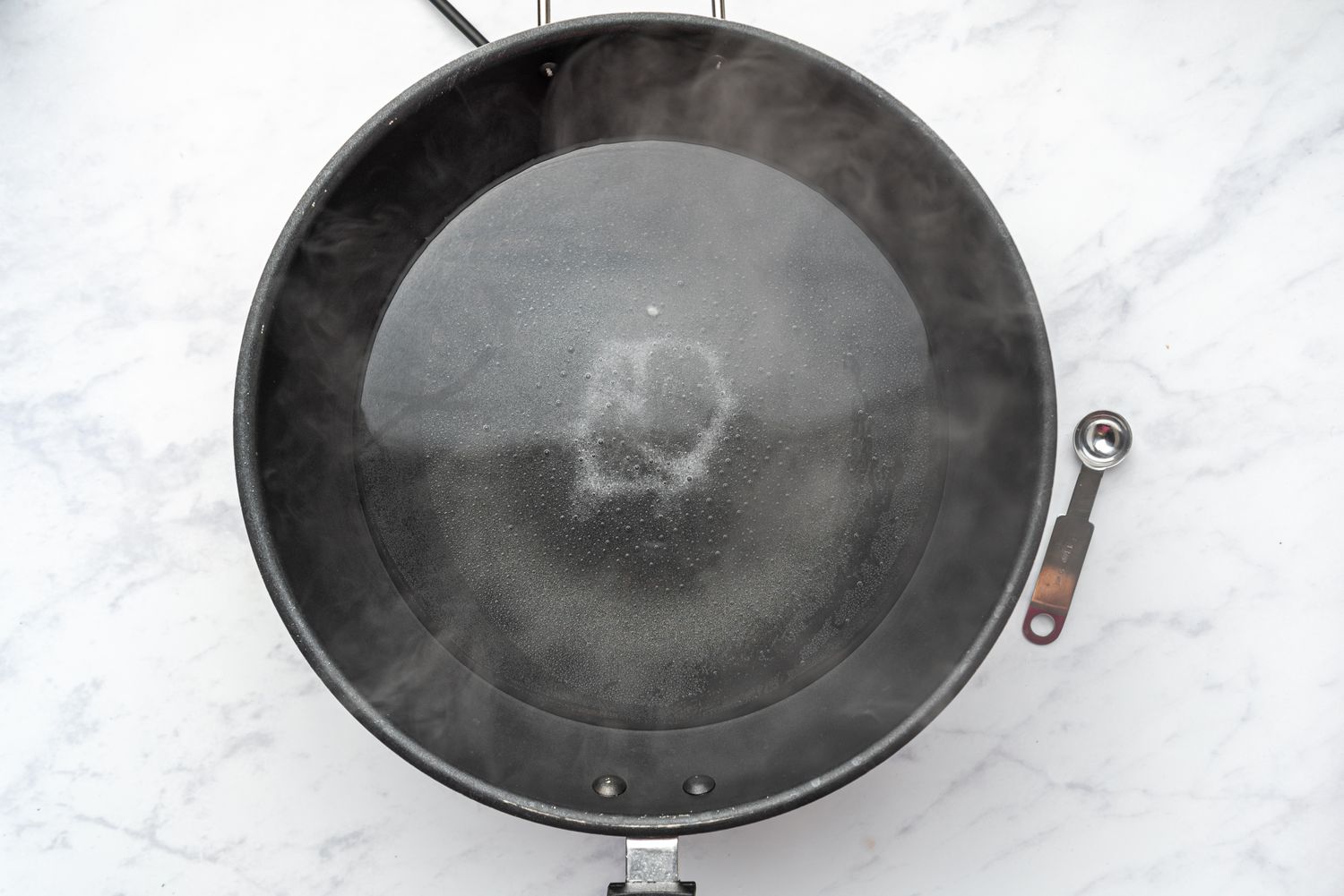 water and salt in a wok