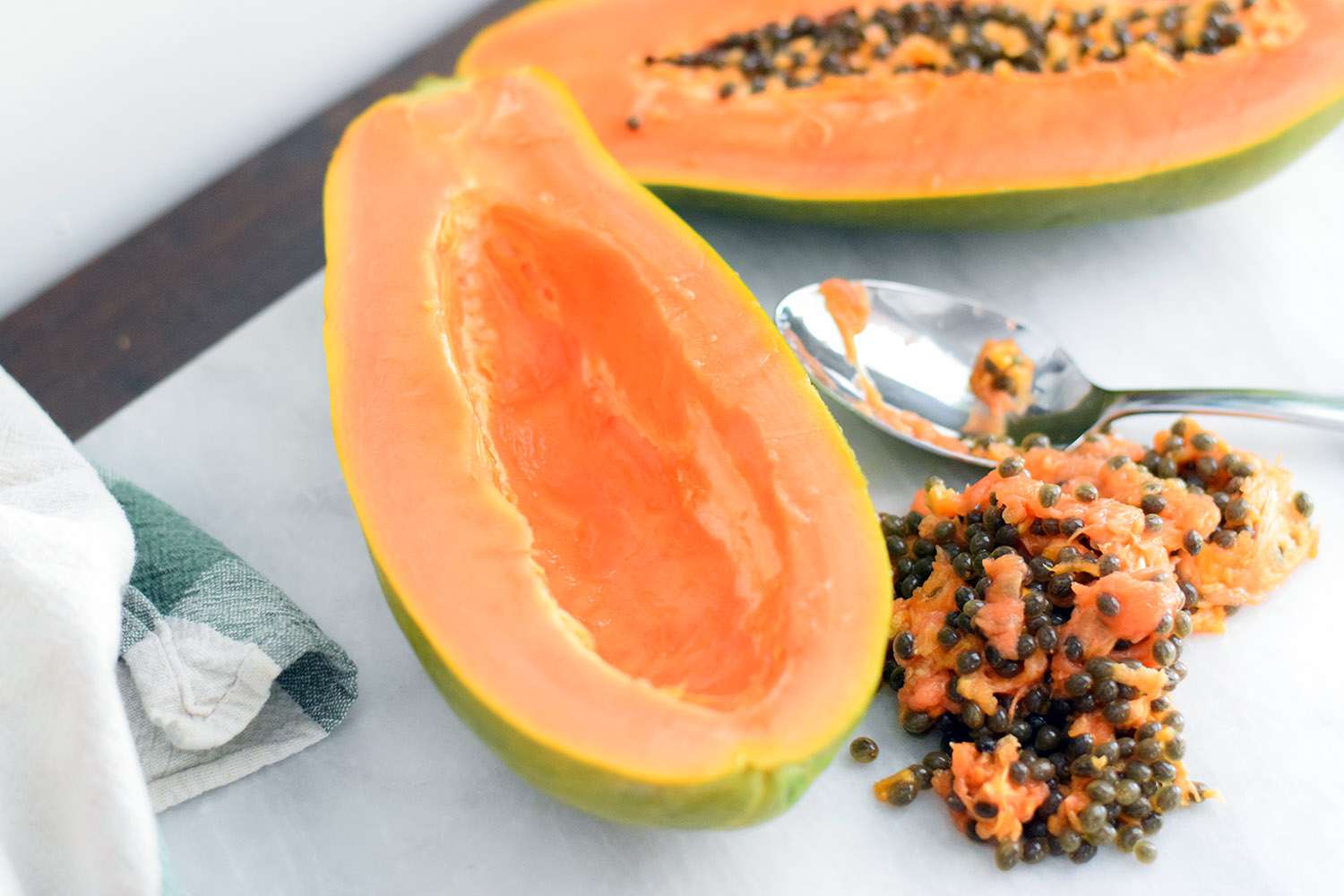 Scrape papaya seeds out with a spoon