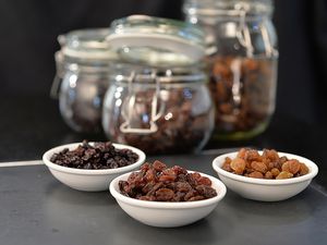 Raisins, currants, and sultanas separated into bowls