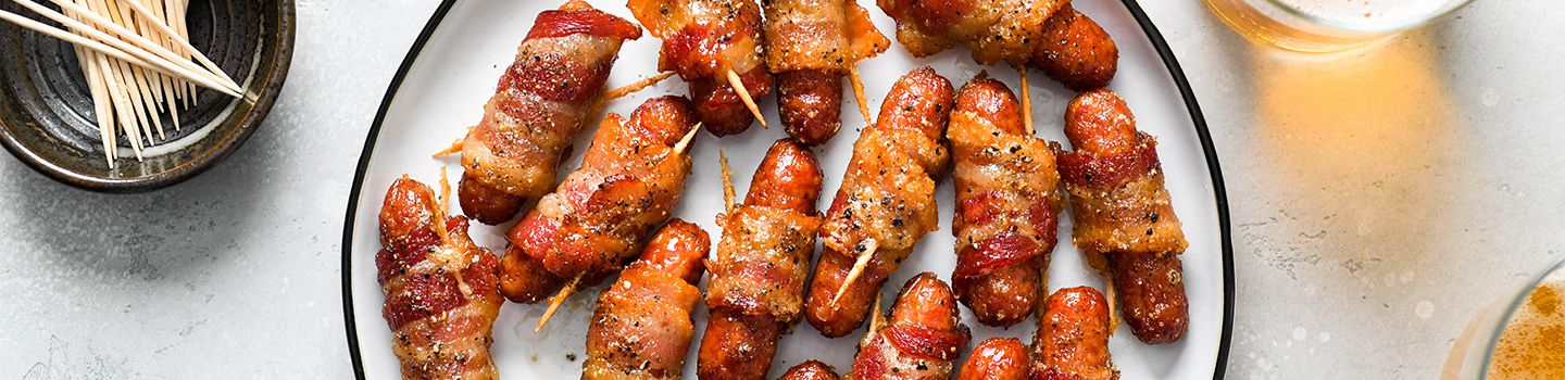 Plate of bacon-wrapped sausages