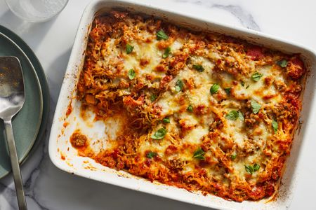 A spaghetti squash and ground beef casserole with a serving removed