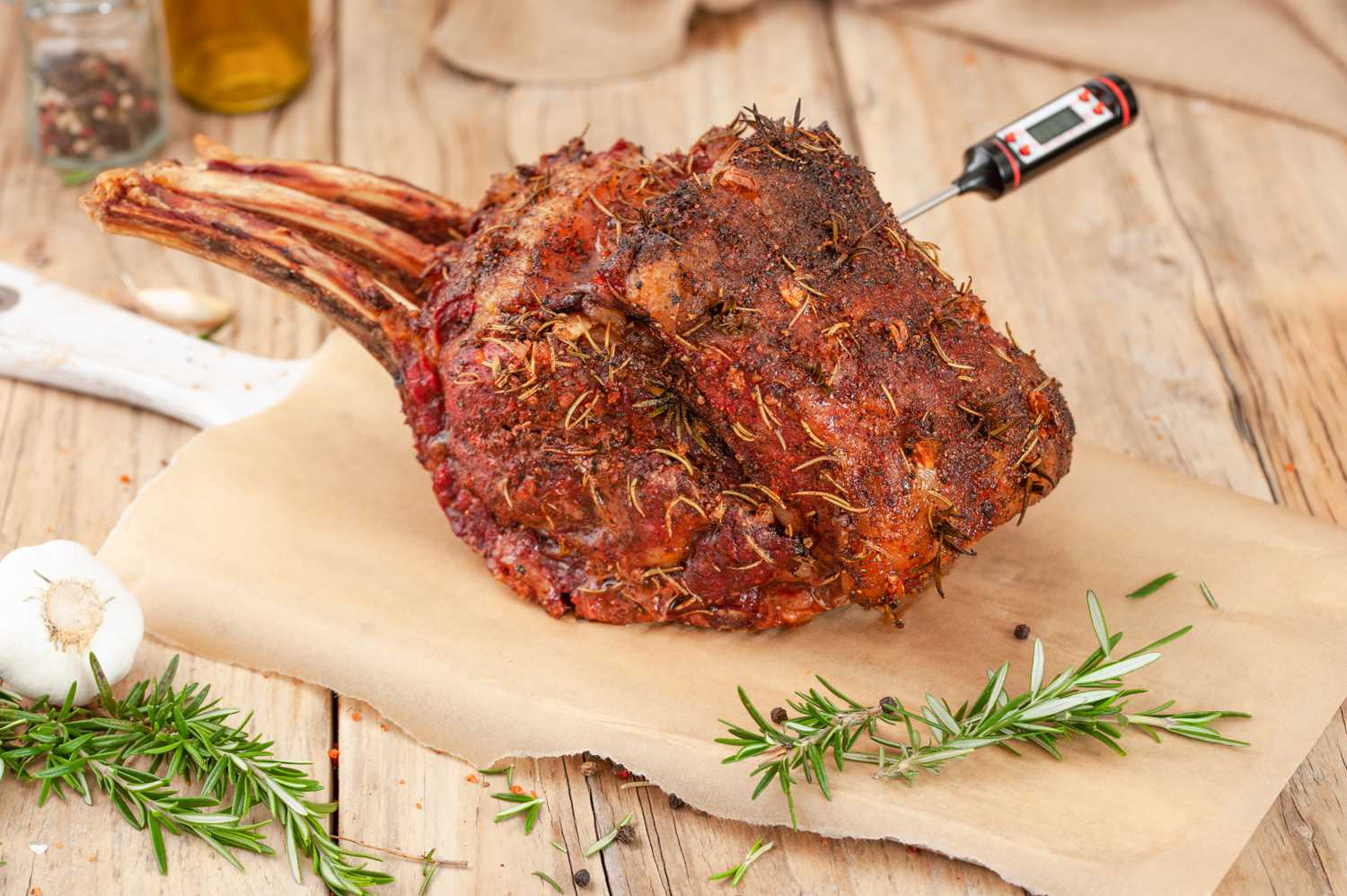 Grilled prime rib roast with meat thermometer inserted 