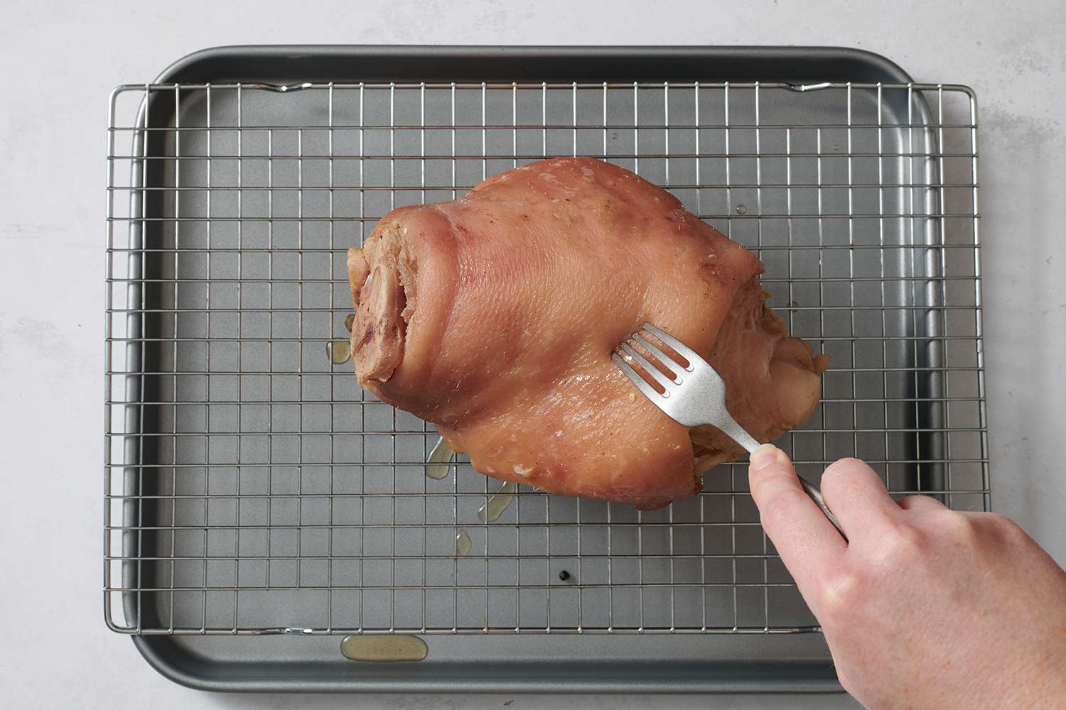 A fork piercing the ham hock