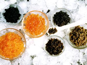 Bowls of caviar and roe on crushed ice