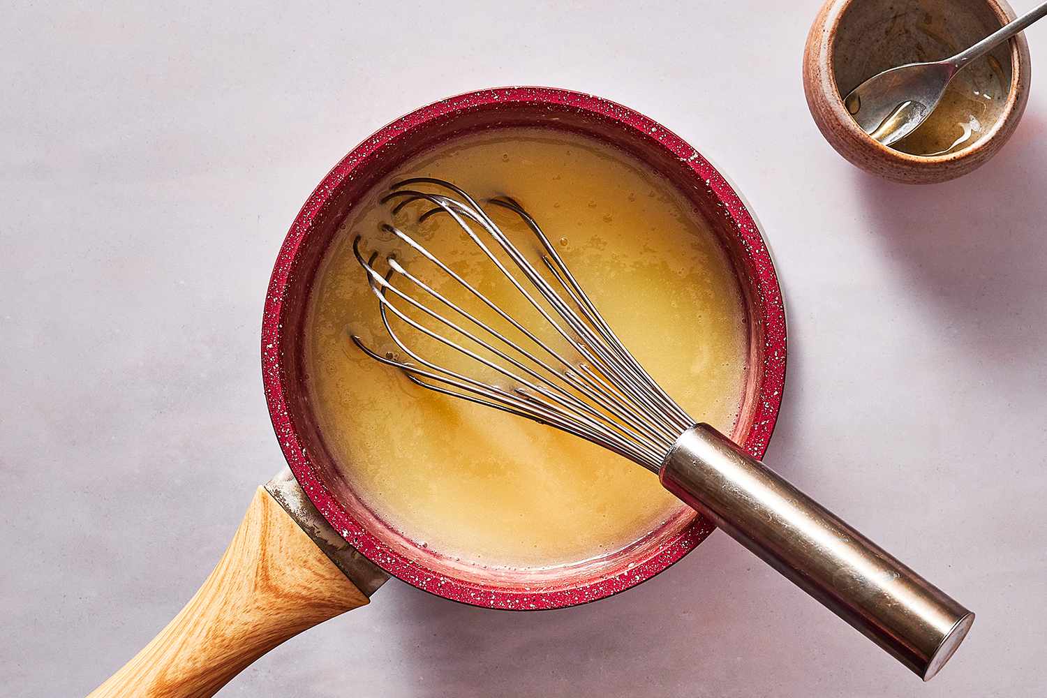 mirror glaze mixture in pan with whisk