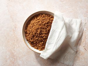 A bowl of brown sugar covered with a wet paper towel