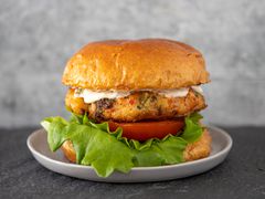 Shrimp burger with special sauce, tomato, and lettuce.