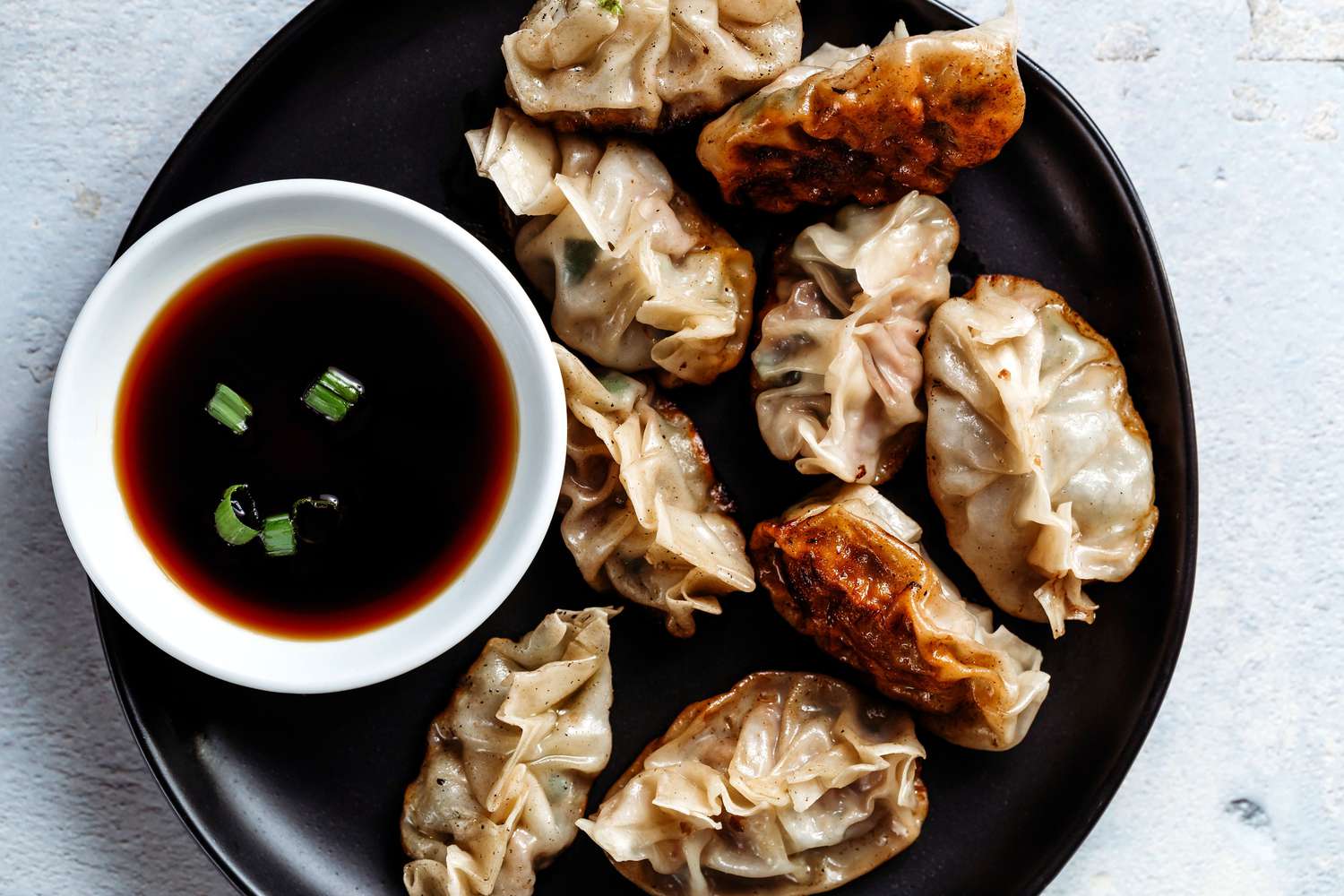 Chinese pan-fried dumplings with dipping sauce