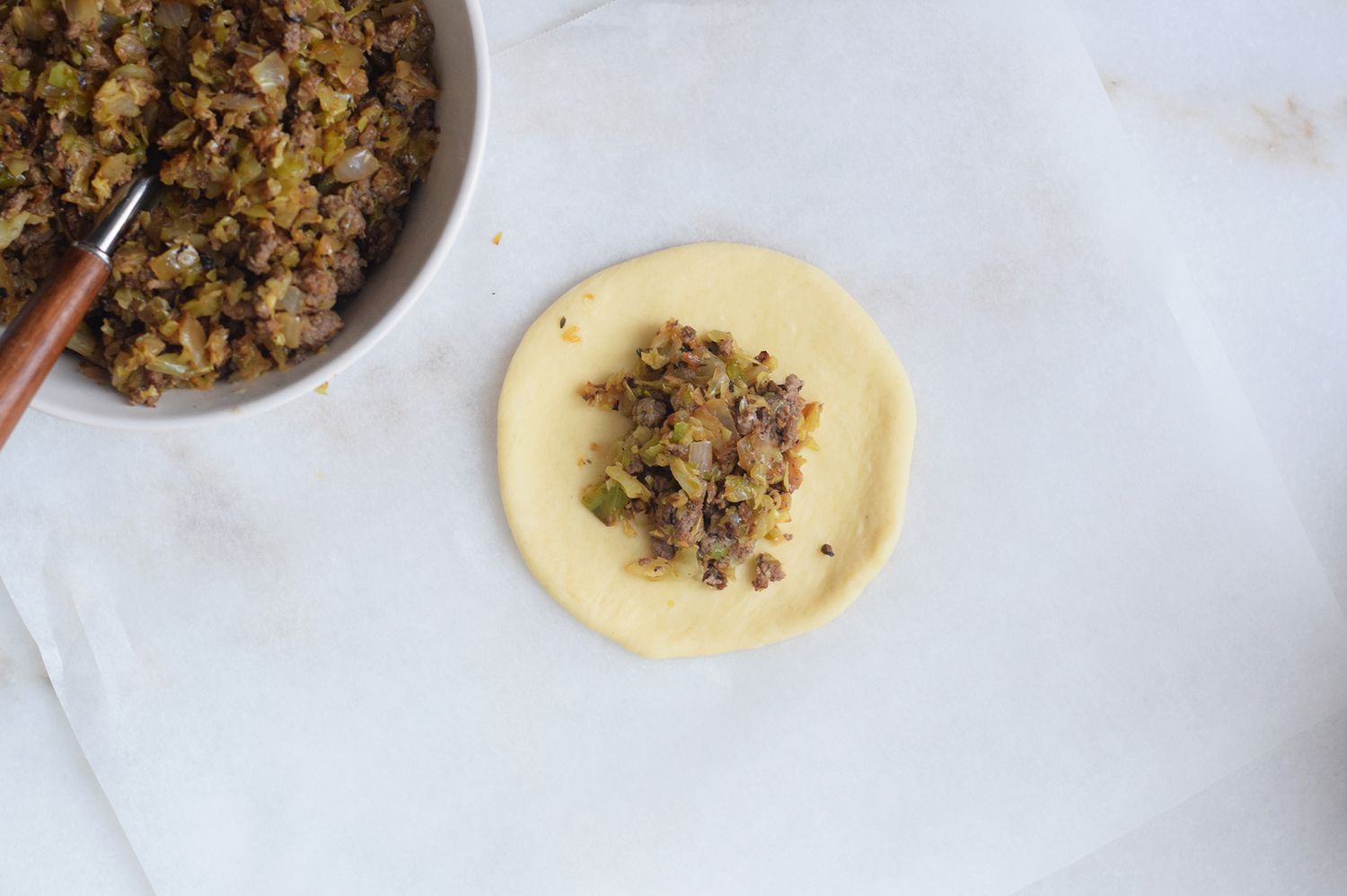 filling spooned onto round of dough