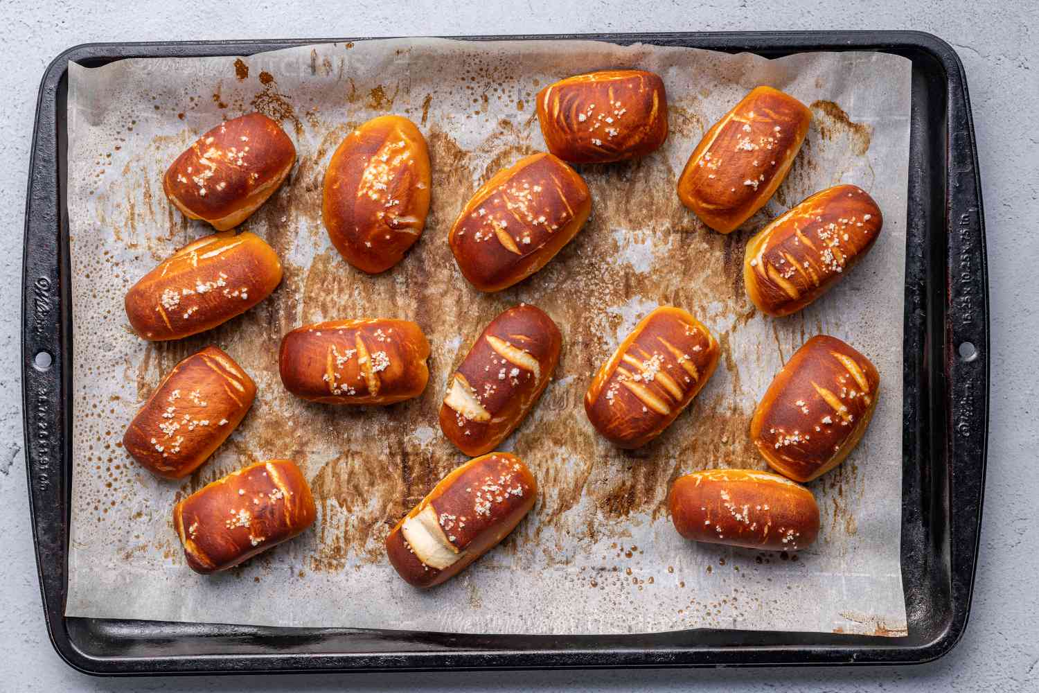 Salt-topped pretzel bites on a baking sheet