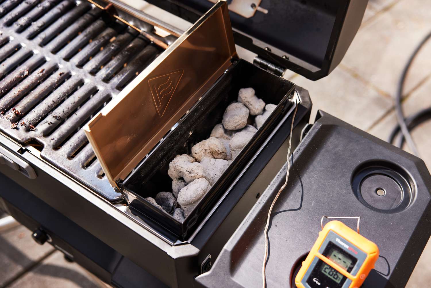 Closeup of charcoal inside of the Masterbuilt Portable Charcoal Grill and Smoker with Cart